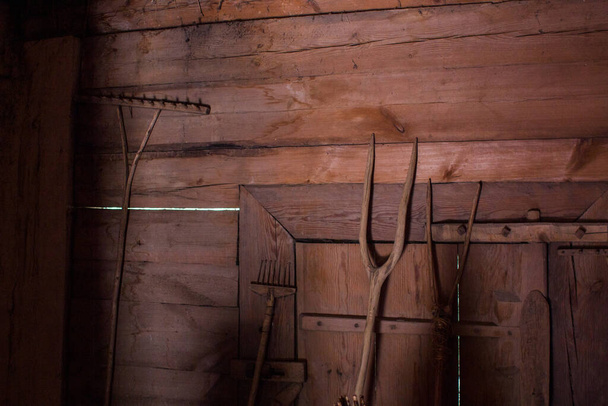 an old wooden pitchfork in the barn - Fotó, kép