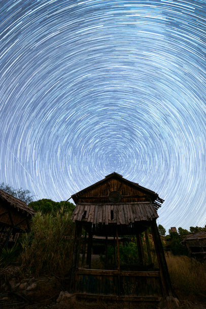 fotografia noturna circunpolar em uma aldeia abandonada em uma noite estrelada - Foto, Imagem