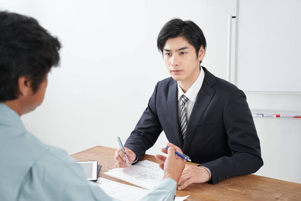 A Japanese male salesperson discussing construction - Photo, Image