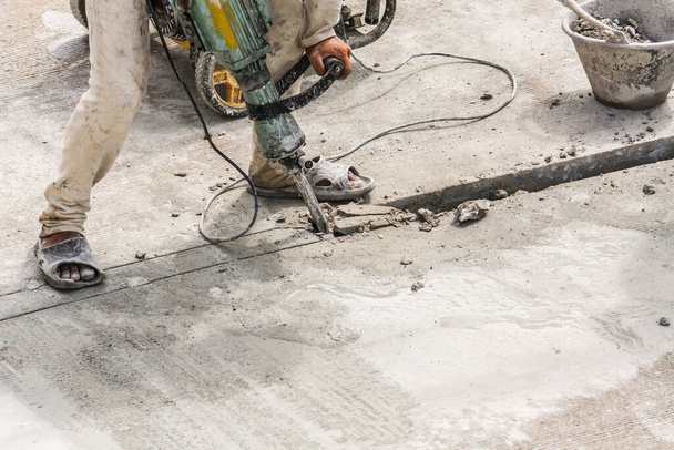 Bouwvakker met behulp van drilboor betonoppervlak - Foto, afbeelding