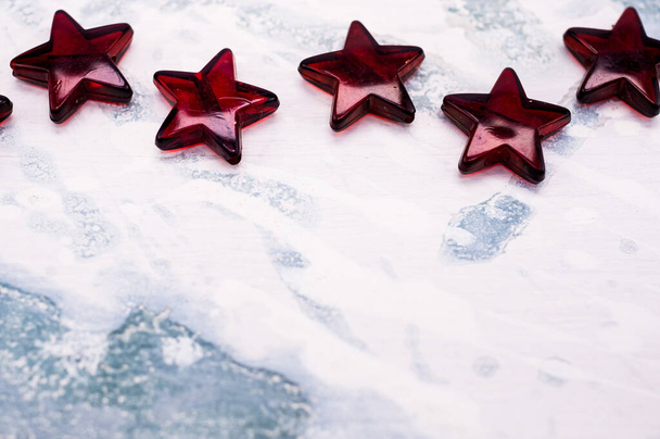 A closeup of red stars on a frosty background - Fotó, kép