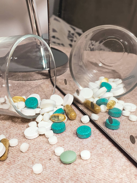A vertical shot of different types of medical pills - Zdjęcie, obraz
