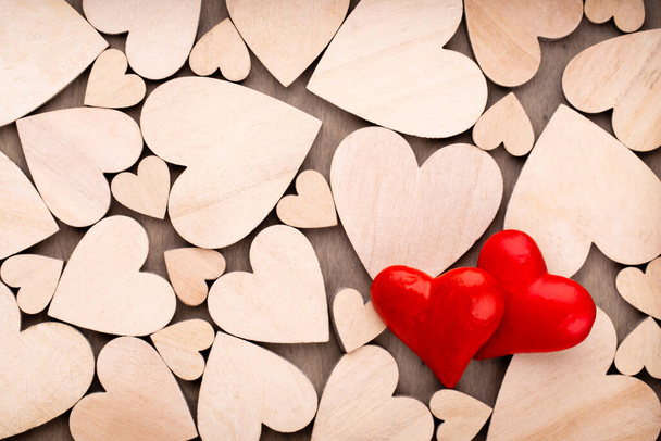 Wooden hearts, one red heart on the wooden heart background. - Foto, afbeelding