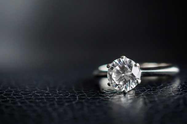 Close up diamond ring jewelry on black leather background - 写真・画像