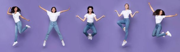 Viisi monirotuinen naiset hyppääminen poseeraa ilmassa yli violetti tausta - Valokuva, kuva