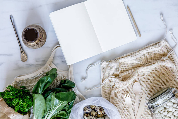 Stylish composition on the marble table with notes, zero waste neutral bags, seeds, eggs, bio vegetables and eco fruits. Taking care of earth. Stop plastic.  - Фото, изображение