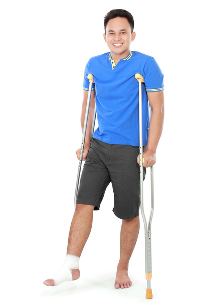 male with broken foot using crutch - Фото, зображення
