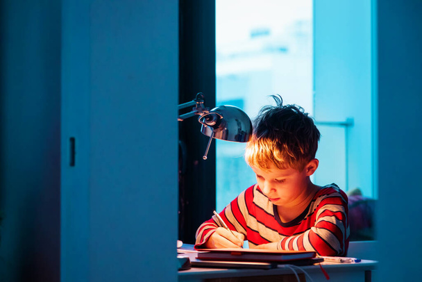 kid doing homework late evening or early morning, procrastination - Foto, Imagen
