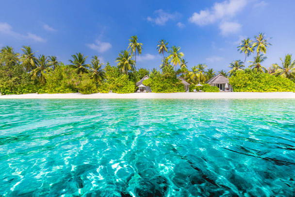 Hermosa playa con palmeras y cielo malhumorado. Vacaciones de verano vacaciones concepto de fondo. Maldivas playa paradisíaca. Viaje de lujo fondo de playa tropical como paisaje de verano. Escena de playa perfecta vacaciones y vacaciones de verano - Foto, imagen