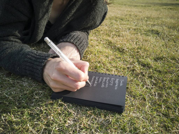 A man is writing something on notebook - Zdjęcie, obraz