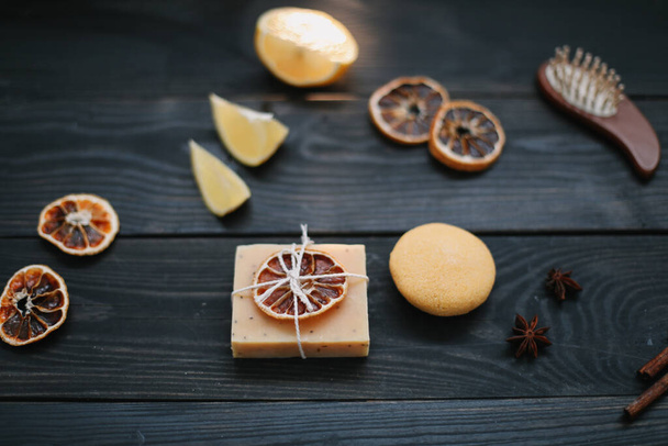 Natural citrus soap on dark background. Concept of Spa, Salon or Home body and skin care. Flat lay. Space for text, top view - Фото, зображення