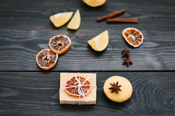 Natural citrus soap on dark background. Concept of Spa, Salon or Home body and skin care. Flat lay. Space for text, top view - Zdjęcie, obraz
