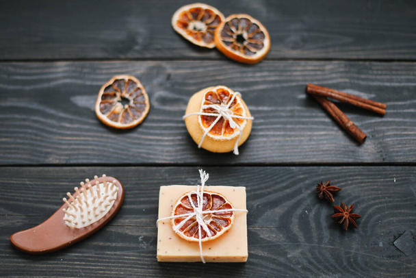 Natural citrus soap on dark background. Concept of Spa, Salon or Home body and skin care. Flat lay. Space for text, top view - 写真・画像