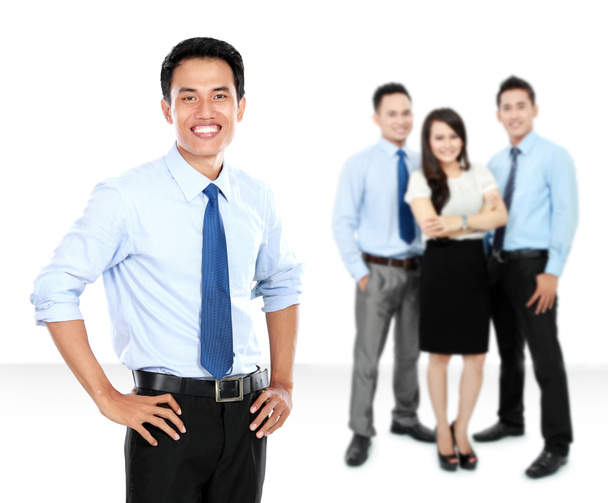 Confident young businessman and business team as background - Photo, Image