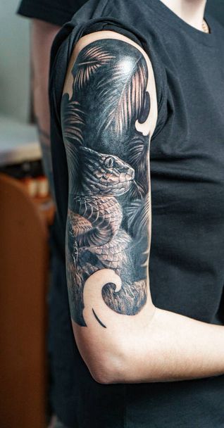 Image of woman with tattoo - snake on her arm - Fotoğraf, Görsel