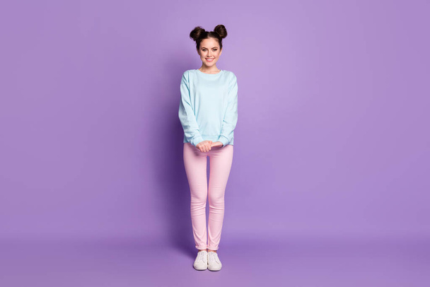 Full body photo of lovely nice girl youth enjoy weekend holiday wear casual style clothes gumshoes isolated over purple color background - 写真・画像