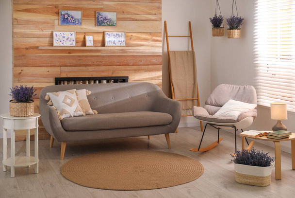 Stylish sofa and rocking chair in beautiful living room interior - Zdjęcie, obraz