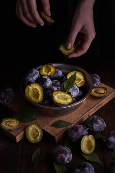 woman preparing plums for jam - 写真・画像
