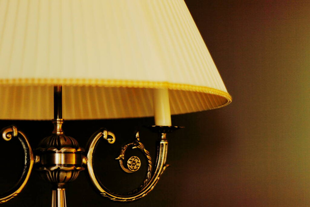 Vintage floor lamp shines with yellow light. - Photo, Image