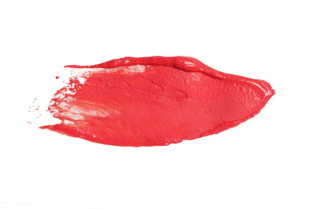 Lápiz labial rojo manchado aislado sobre fondo blanco - Foto, imagen