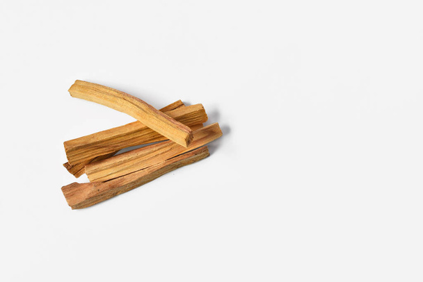 A top view image of several sticks of palo santo wood on a white background.  - Photo, Image