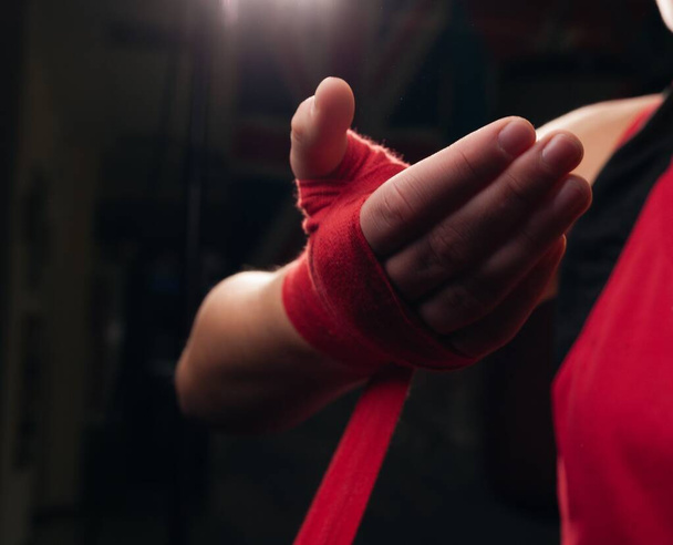 Boxermädchen in roten Boxbändern in Großaufnahme. - Foto, Bild