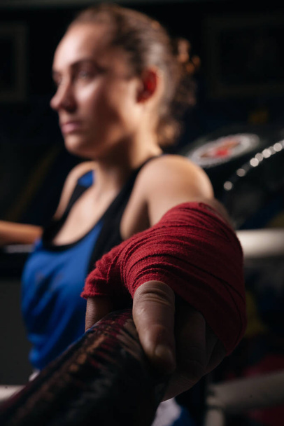 Boxer girl in red boxing bands close-up. - 写真・画像