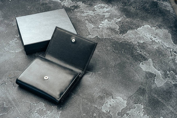 New black leather wallet on dark background - Fotó, kép