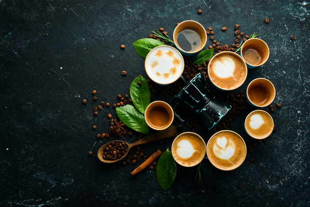 Set of coffee drinks: espresso, cappuccino, latte and Americano. On a black stone background. Top view. - Fotoğraf, Görsel