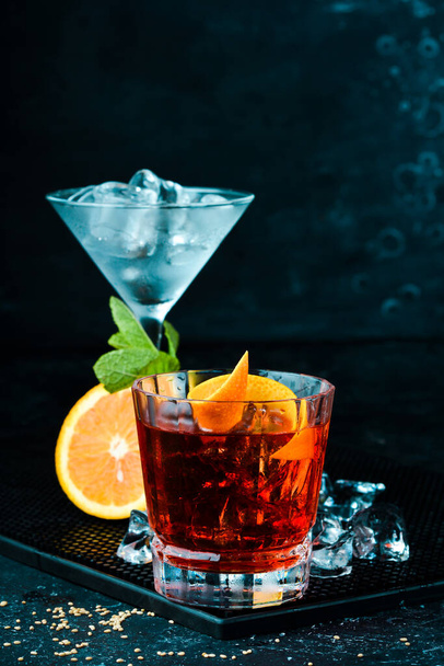 Traditional Negroni cocktail on black stone background. Menu bar. Alcohol. - Фото, изображение