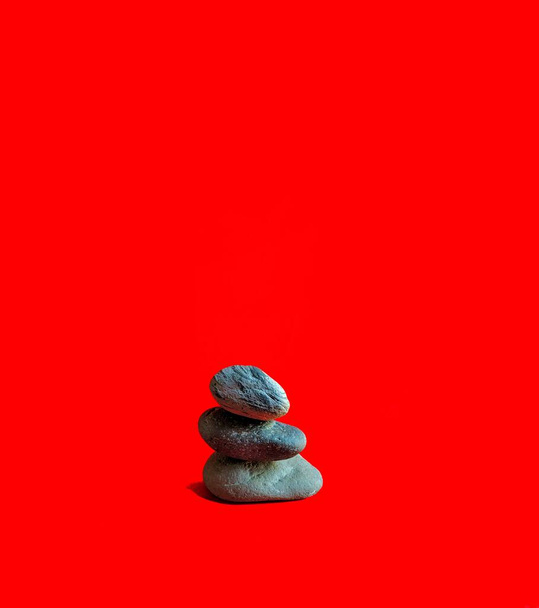 River stones on red background. decorative concept - Фото, зображення