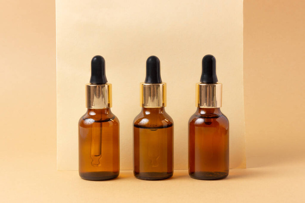 A set of amber bottles for essential oils and cosmetics. Glass bottle. Dropper, spray bottle - Valokuva, kuva