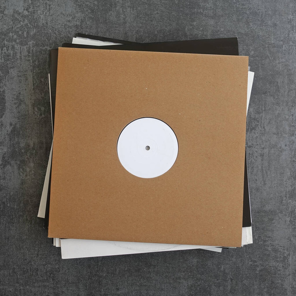Pile of promo vinyl records in cardboard sleeves. Placer your logo or artwork on the cover and the white label. - Photo, Image