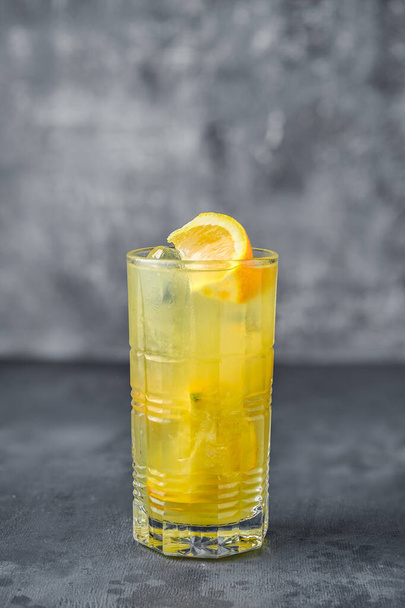 Alcohol cocktail with rum and orange juice on gray background - Fotoğraf, Görsel