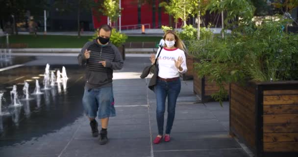 Ζευγάρι με μάσκα σε μια βόλτα συζητώντας - Πλάνα, βίντεο