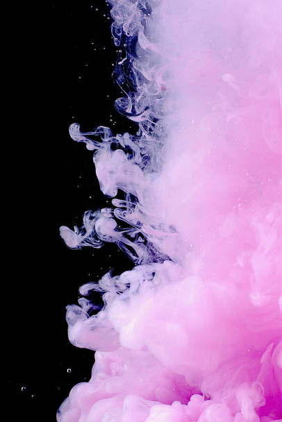 Beautiful pink abstraction on a dark background made of paint in water - Foto, Imagem