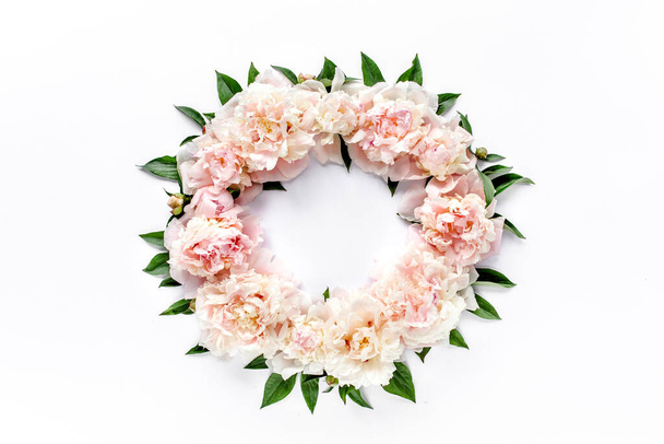 Floral round frame wreath made of pink and beige peonies flower buds, eucalyptus branches and leaves isolated on white background. Flat lay, top view. - Fotografie, Obrázek