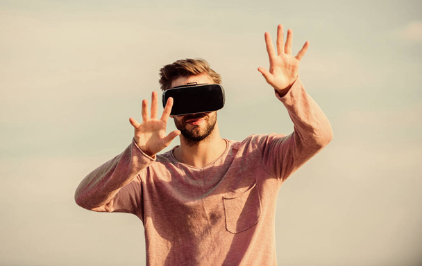 Man explore VR sky background. VR technology and future. VR communication. Exciting impressions. Gaming and entertainment. Interaction with digital surface. Gesture control. 3d visualization - Foto, Imagem