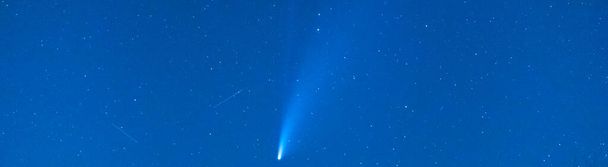 Huella de estrella fugaz o un cometa en un cielo estrellado azul con estrellas en la noche. Astronomía o fondo navideño. - Foto, imagen