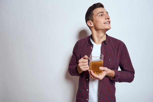 Cheerful man with mug of beer alcohol emotions light background - Foto, Imagem