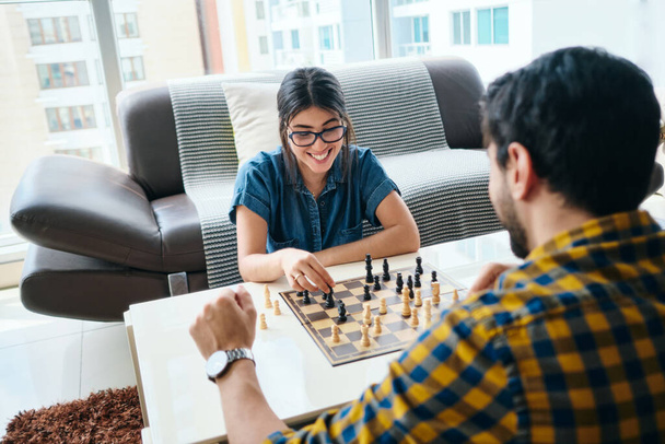 Young Man And Woman Having Fun And Playing Chess - Φωτογραφία, εικόνα