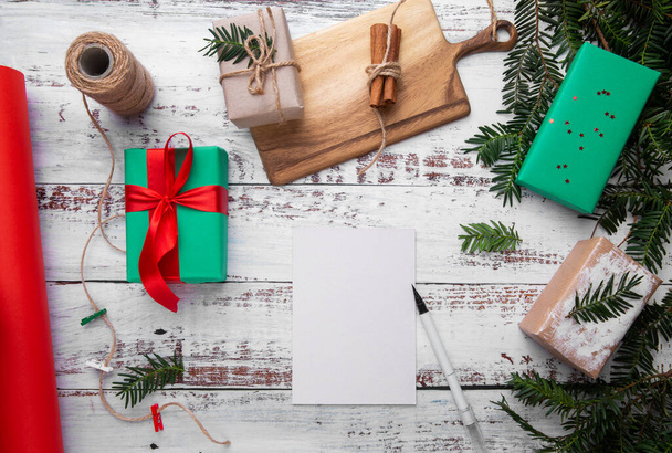 postcard and pen lie on a wooden table next to gifts - 写真・画像