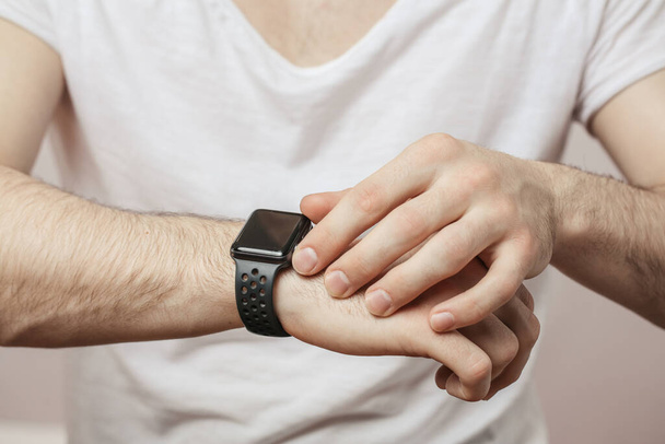cropped photo of a man wearing smartwatch - Zdjęcie, obraz