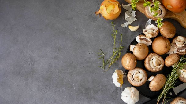 Brown raw mushrooms, cooking healthy food, top view. Dark backgrouns. - Fotó, kép