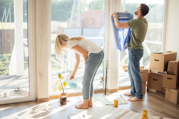 couple working, clining in new apartment with big window wall - Fotoğraf, Görsel