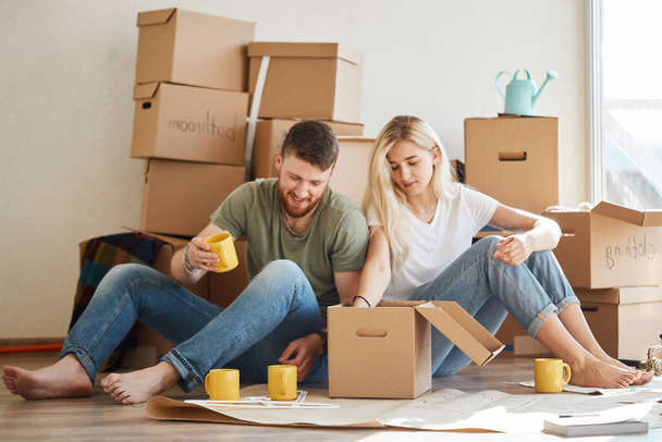 couple in new apartment unpacking cardboard boxes - Photo, Image
