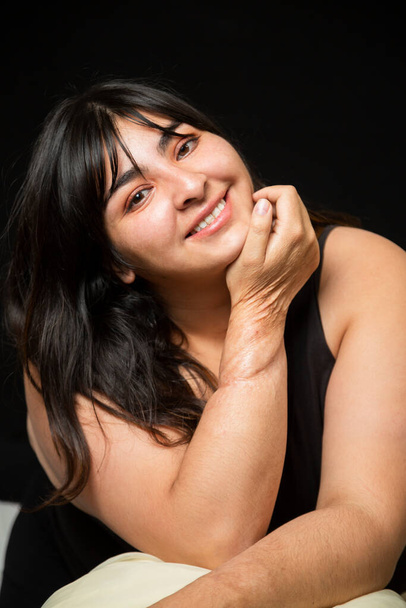 Portrait Hispanic woman smiling looking at camera on black background - inclusive beauty- curvy woman - body positive character, feminism, self love, beauty concept - Photo, Image