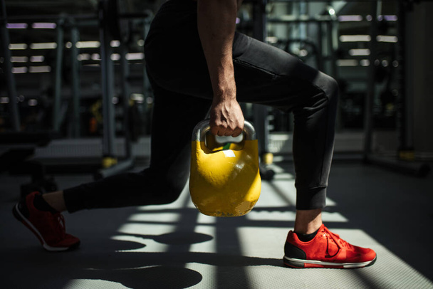 Young fitness man is training by kettlebell. - Foto, Imagem