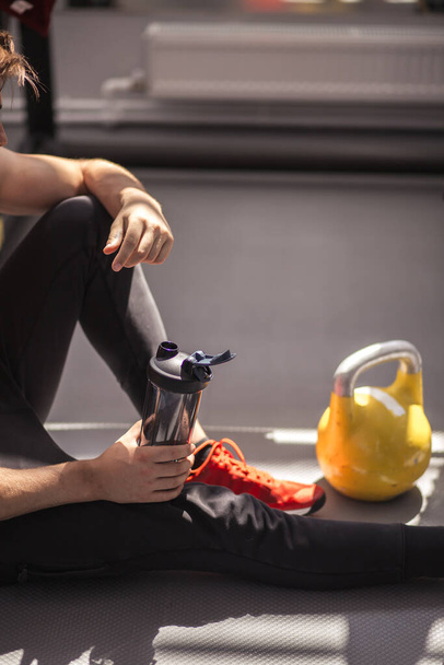 Sporty man in red sportive shoes before practice. Male athlete preparing for workout. Runner getting ready for training. Sport active lifestyle concept. Close-up - Fotoğraf, Görsel