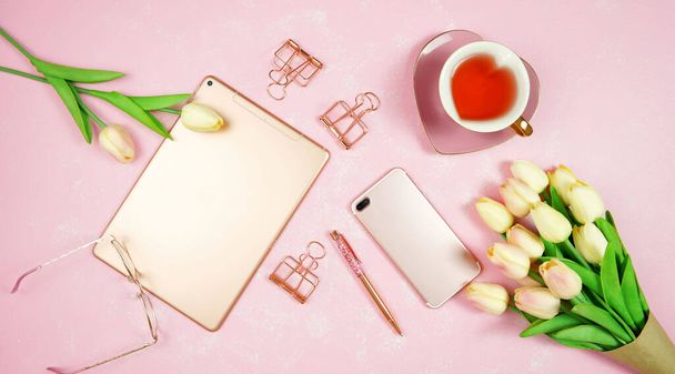 Vrouwelijke roze desktop werkruimte blog header overhead platte lay. - Foto, afbeelding